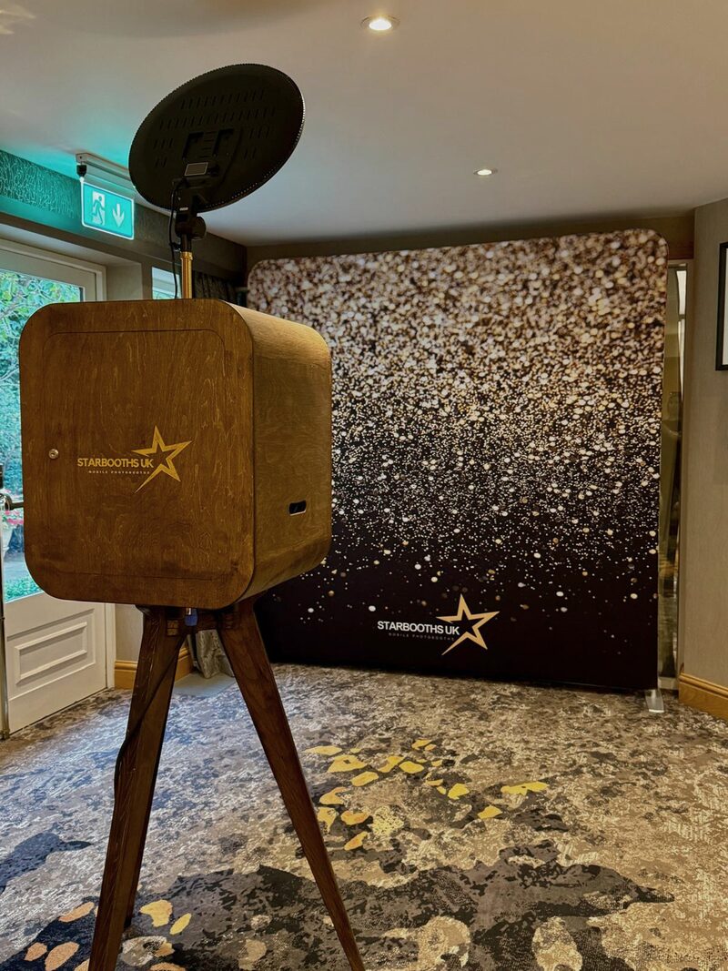 Vintage wooden booth on a gold sparkle backdrop